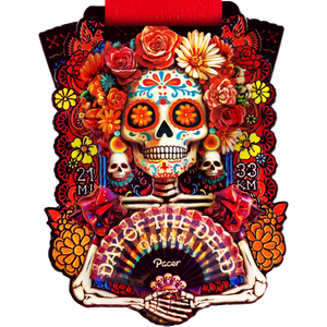 Colorful Day of the Dead medal from the Oaxaca Virtual Challenge featuring a decorated skull and floral design.